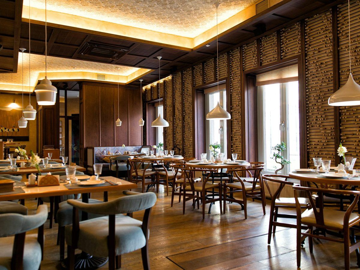 A warmly lit restaurant dining room set for service